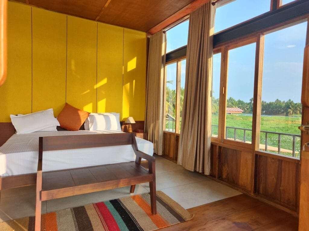 Villa sitting area with paddy field view at Kyna Backwaters, Kainakary