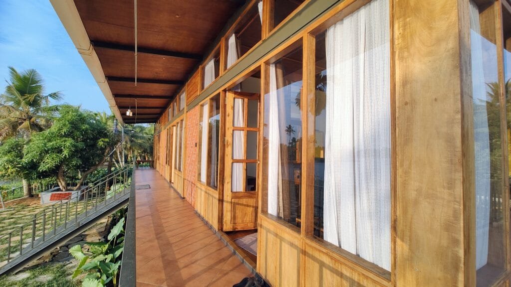 Wooden veranda with backwater views at Kyna Backwaters, Kainakary