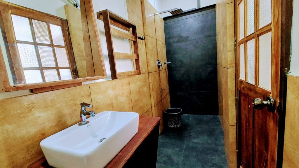 Attached bathroom with vessel sink in a villa at Kyna Backwaters