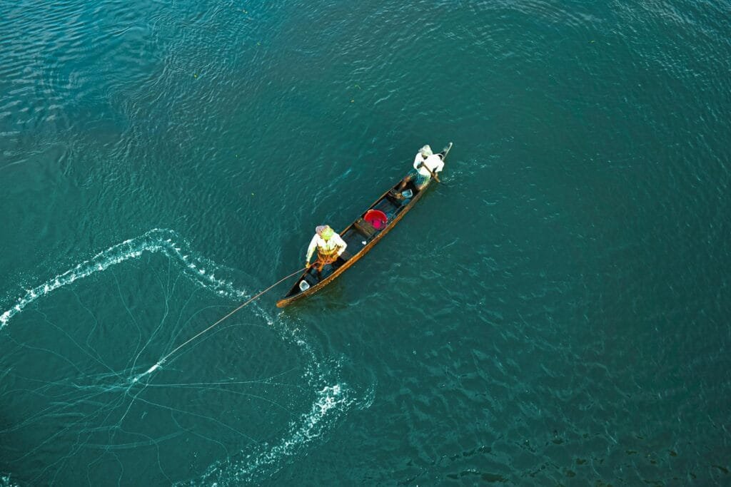 Aerial view of a fisherman in a canoe on a Kerala backwater