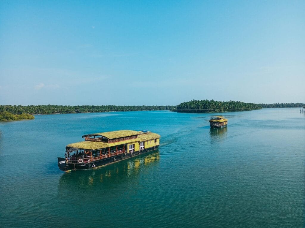 Aerial view of a Kerala houseboat cruising across the Vembanad backwaters