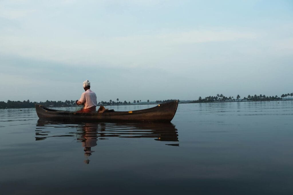 Traditional canoe on calm backwaters in Kerala